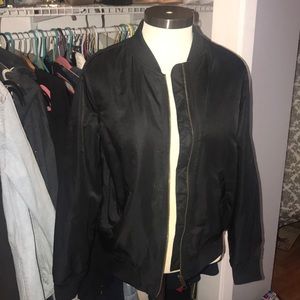 Black bomber jacket with zipper in the middle.